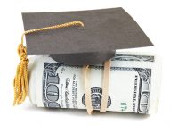 mini graduation cap on rolled up cash