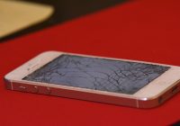 Broken iPhone on red background