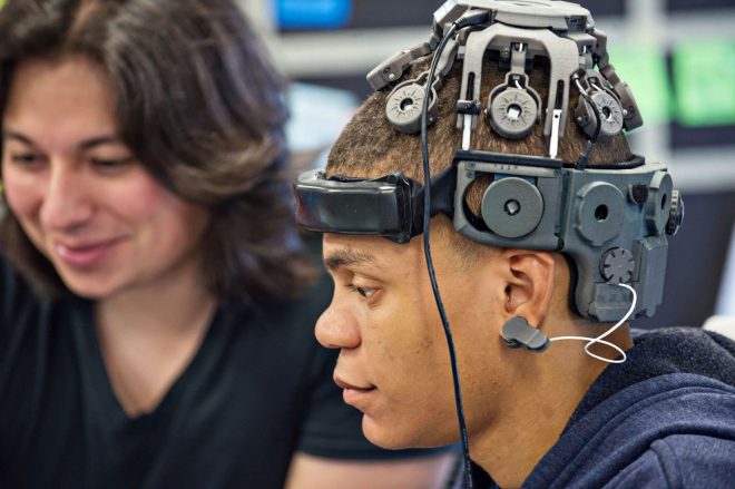 Side view of man wearing headgear with sensors.