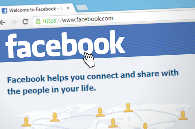 Screenshot of Facebook page with hand icon.