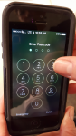 Photo of hand punching in passcode on a smartphone