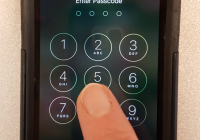 Photo of hand punching in a passcode on a smartphone