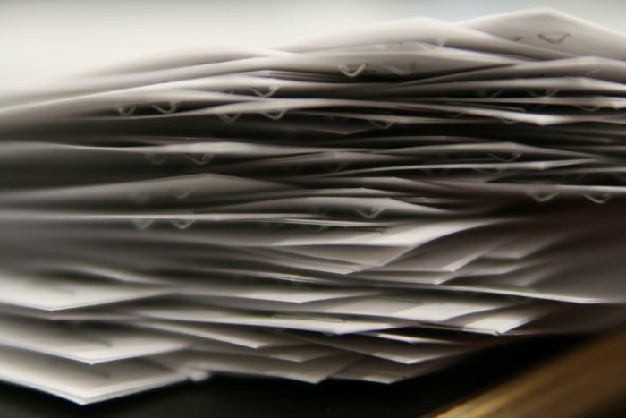 close up photo of a stack of stapled papers
