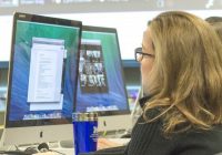 Photo of woman looking at computer screen.