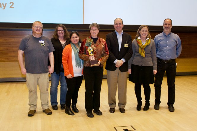 The winning team, TriggerFigureOuter, on stage with the judges