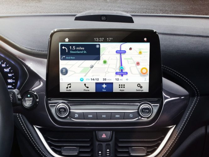 Photo of car dashboard screen with Waze nav activated.