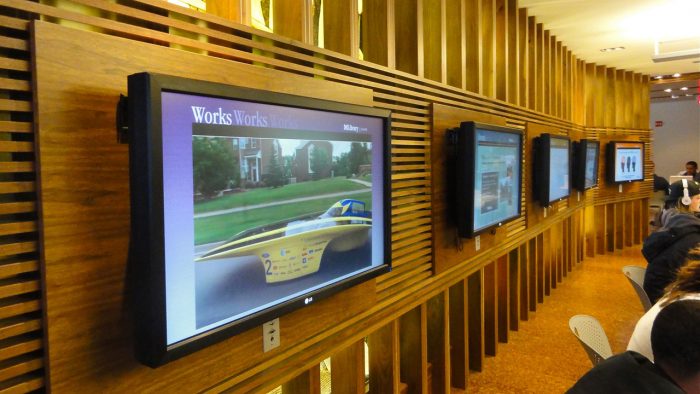 Photo of a wall in the Shapiro Library with several digital signs.