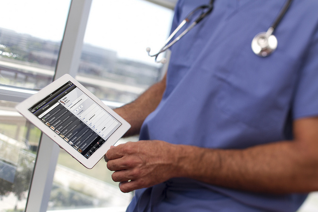 Doctor holding iPad showing medical record