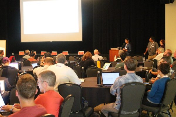 Presenter with room of attendees