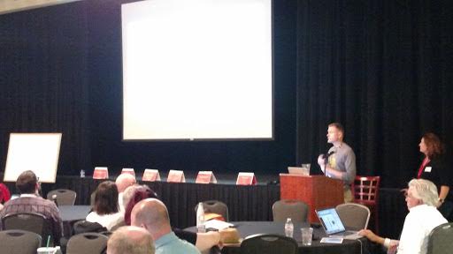 presenter with room of attendees