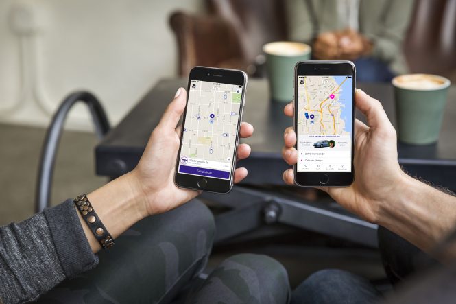 hands holding smartphones showing Lyft app