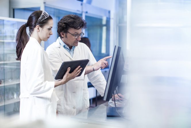 Two Scientist Looking at the Computer Monitor,