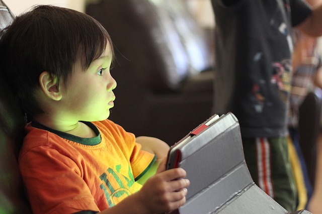 young boy holding tablet