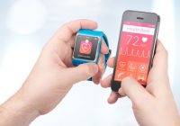 data synchronization of health book between smartwatch and smartphone in male hands