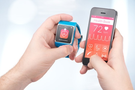 data synchronization of health book between smartwatch and smartphone in male hands