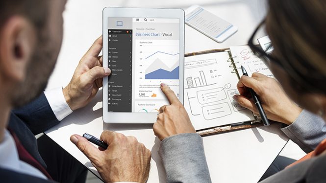 man and woman looking at data charts on a tablet