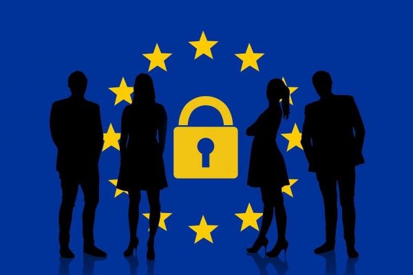 silhouette of people standing in front of EU flag with a lock in the middle