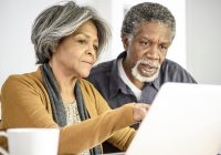 Older man and woman looking at a computer
