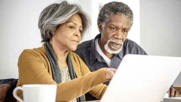 Older man and woman looking at a computer