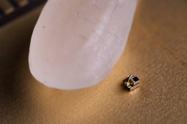 "Device next to a grain of rice"