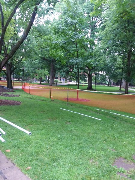 Diag with broken ground and pile of PVC pipe