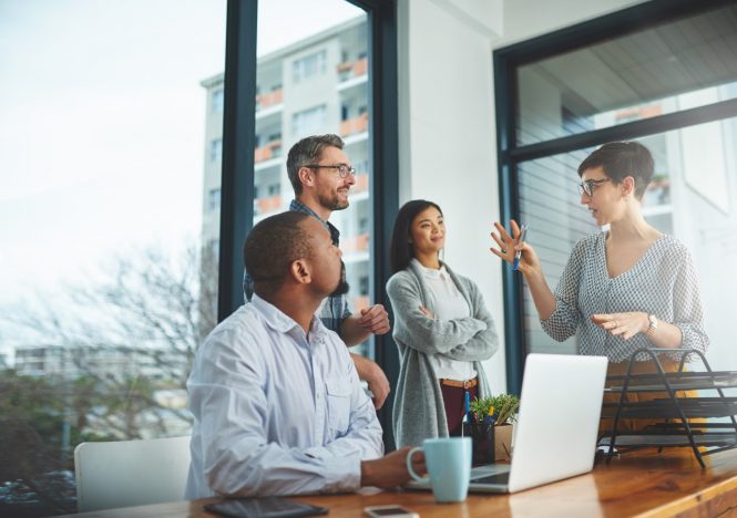 A group of colleagues having a discussion in a modern office