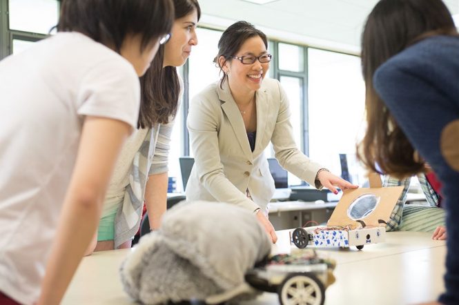 Female professor surrounded by female students.