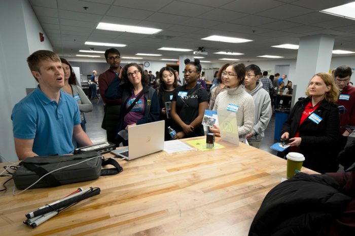 Brandon Werner demonstrates assistive technology for WIAD 2019 attendees at the Deque Empathy Lab, an immersive accessibility learning experience that showcases how people with disabilities use technology