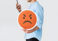 man holding phone and angry face emoji icon