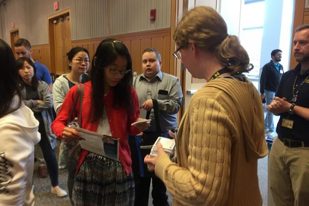 Debra McCaffrey, research liaison, talks with a customer about the Electronic Research Notebook. 