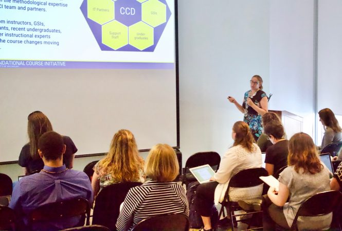 Woman giving presentation to room of people