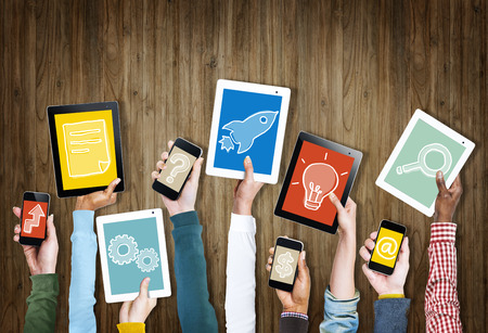 group of hands holding digital devices with symbols