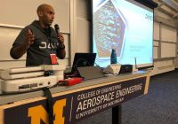 African-American man wearing JAIC sweatshirt giving a presentation.