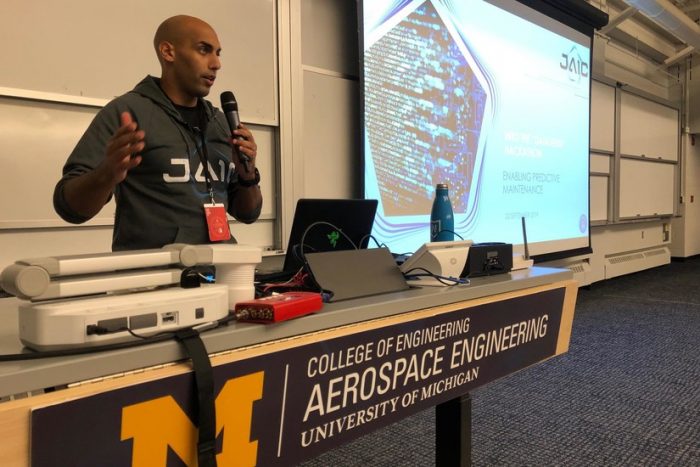 African-American man wearing JAIC sweatshirt giving a presentation.