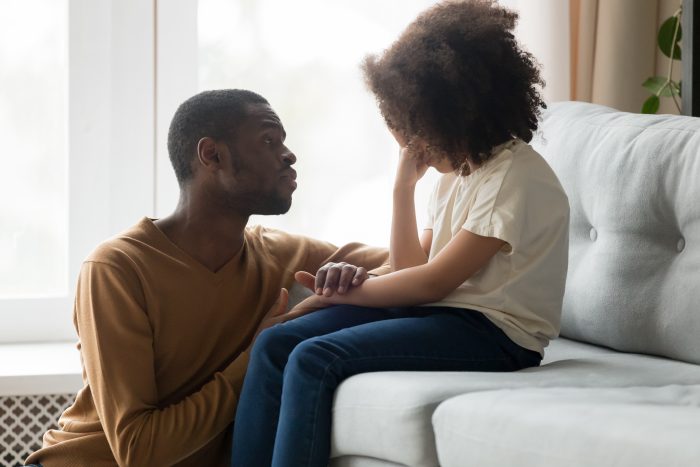 black father consoling talking to upset child giving empathy protection
