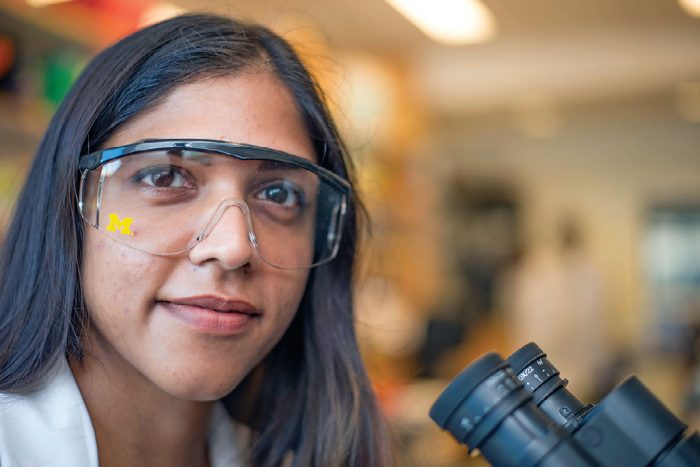 Researcher with U-M branded eye protection