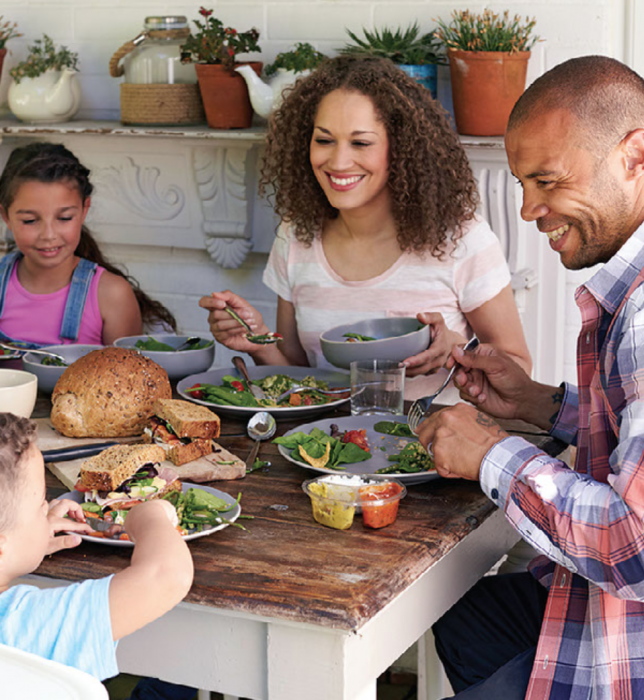 Black family sitting around dinner table