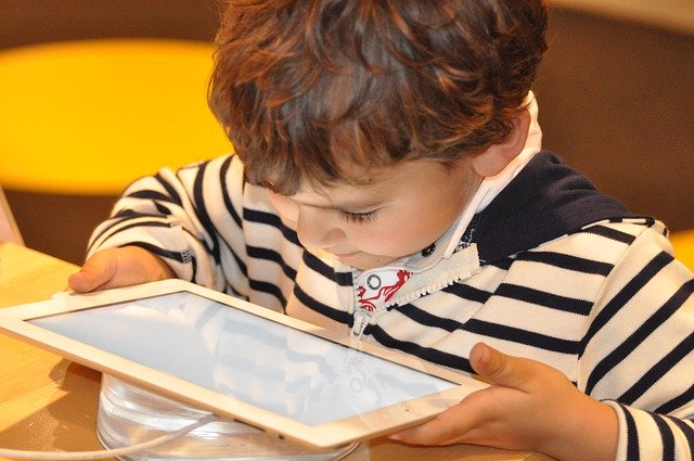 little boy using a tablet computer