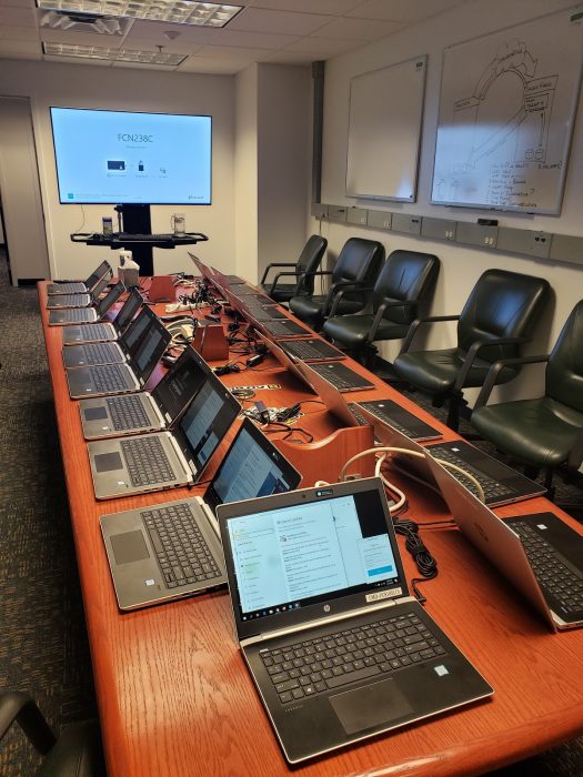 Table with dozens of laptops,