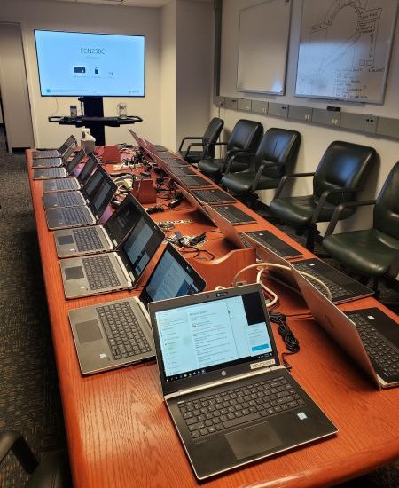 Table with dozens of laptops,