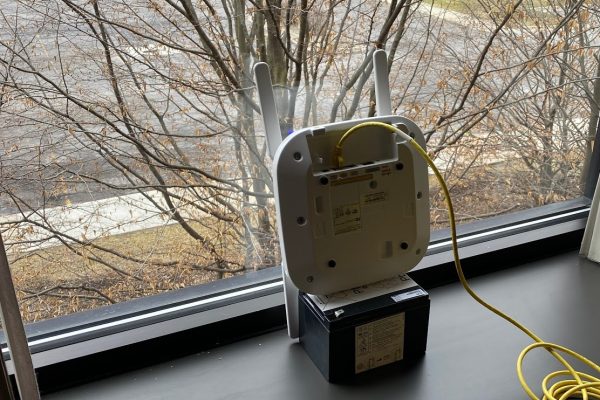 Access point device in window overlooking parking lot.