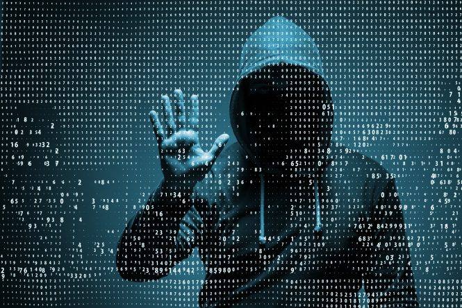 hooded hacker behind wall of digital numbers