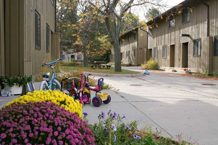 Exterior of Northwood 4 apartments with flowers and bicycles in the foreground.