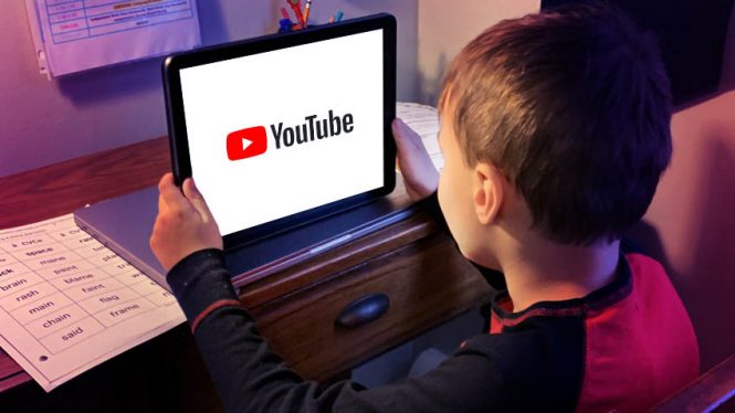 young boy watching YouTube on a tablet