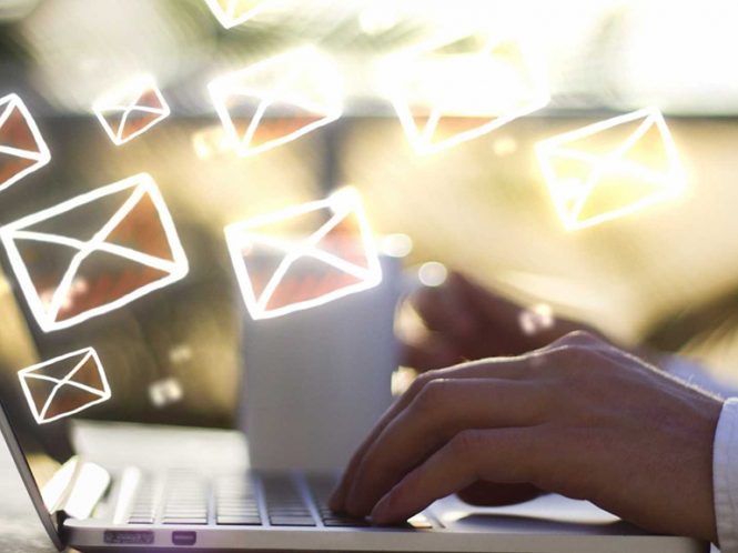 hands on laptop keyboard with images of email icons floating above