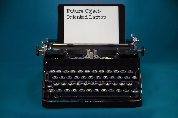 A typewriter with an iPad propped up where the paper usually goes. The iPad reads "Future Object-Oriented Laptop"
