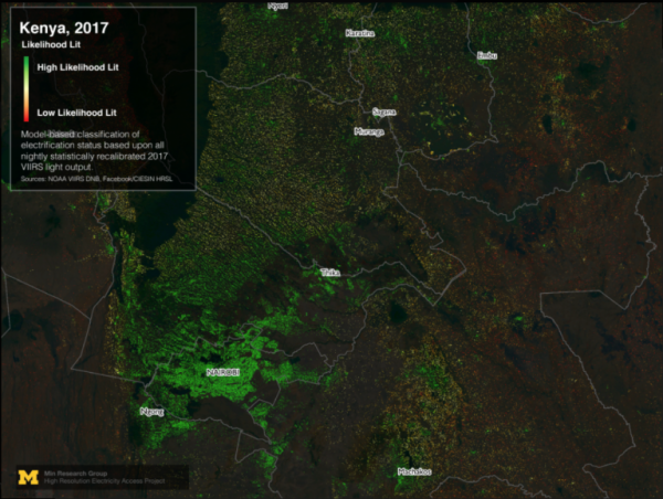 An aerial view of Kenya at night, with concentrations of green dots that display areas that are electrified. 