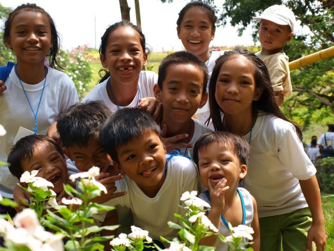A group of children being playful for the camera.