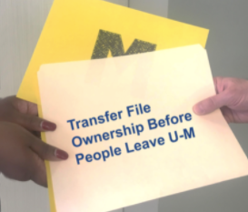 A file folder is handed from one person to another.