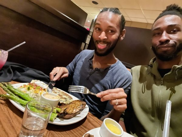 Two people are featured at a restaurant table: Doug Adams on the right with his fiance Coretz Lilley on the left.